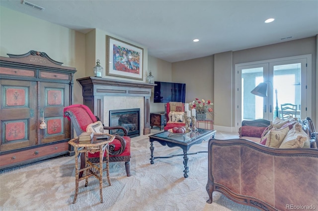 carpeted living room with french doors and a tile fireplace