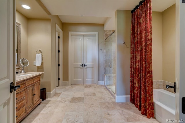 bathroom with vanity and independent shower and bath