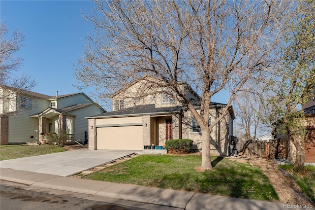 2875 S Tower Way, Aurora, CO 80013 - traditional home featuring an attached garage, brick siding, and driveway