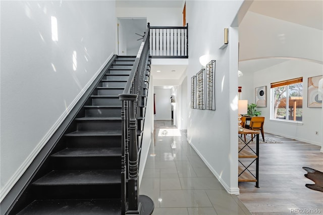 2875 S Tower Way, Aurora, CO 80013 - staircase with arched walkways and a towering ceiling
