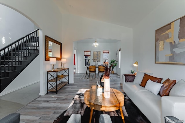 2875 S Tower Way, Aurora, CO 80013 - living area featuring arched walkways, stairway, and wood finished floors