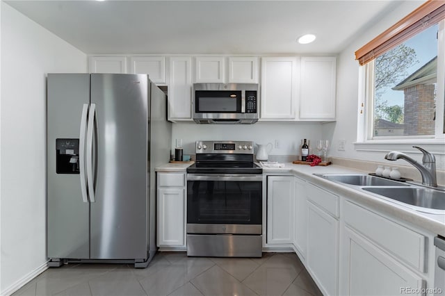 2875 S Tower Way, Aurora, CO 80013 - kitchen featuring appliances with stainless steel finishes, white cabinets, light countertops, and light tile patterned floors
