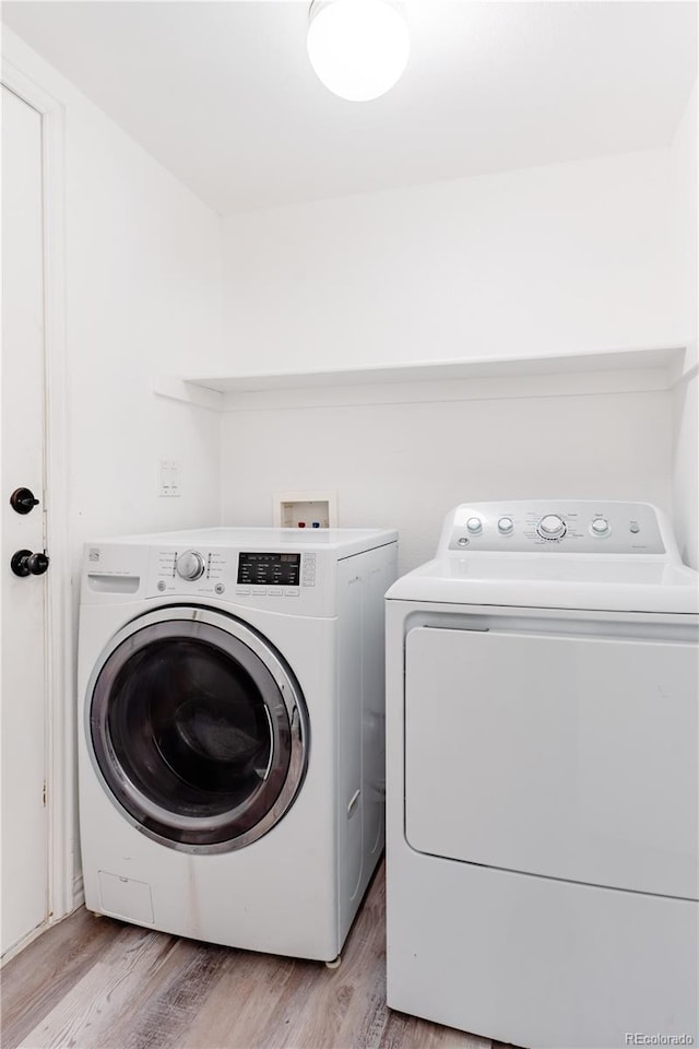2875 S Tower Way, Aurora, CO 80013 - laundry room featuring washer and dryer and light wood finished floors