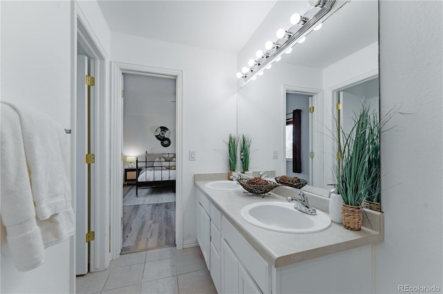 2875 S Tower Way, Aurora, CO 80013 - full bathroom featuring double vanity, tile patterned floors, and ensuite bath