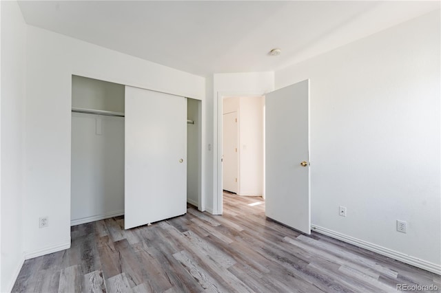 2875 S Tower Way, Aurora, CO 80013 - unfurnished bedroom featuring wood finished floors and a closet
