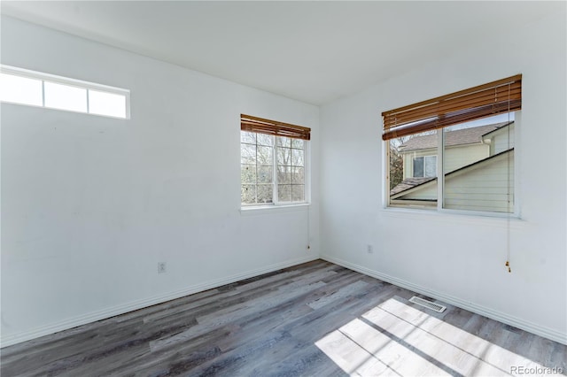 2875 S Tower Way, Aurora, CO 80013 - unfurnished room with healthy amount of natural light and wood finished floors