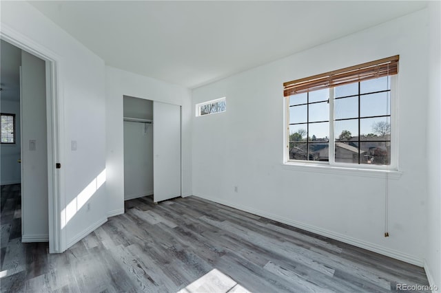 2875 S Tower Way, Aurora, CO 80013 - unfurnished bedroom with wood finished floors and a closet