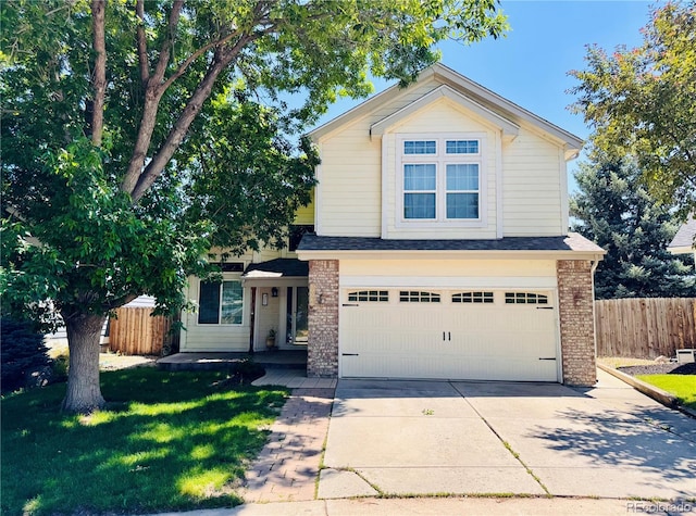 10064 Westside Cir, Littleton, CO 80125 - traditional home with concrete driveway, an attached garage, and brick siding