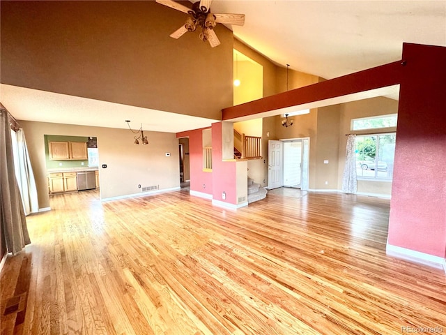 10064 Westside Cir, Littleton, CO 80125 - unfurnished living room featuring light wood finished floors, a ceiling fan, and high vaulted ceiling