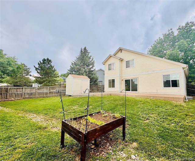 10064 Westside Cir, Littleton, CO 80125 - fenced backyard featuring a vegetable garden and a shed