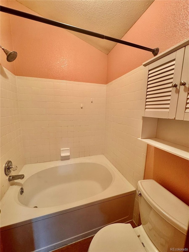 10064 Westside Cir, Littleton, CO 80125 - bathroom with a textured wall, a textured ceiling, bathing tub / shower combination, and vaulted ceiling