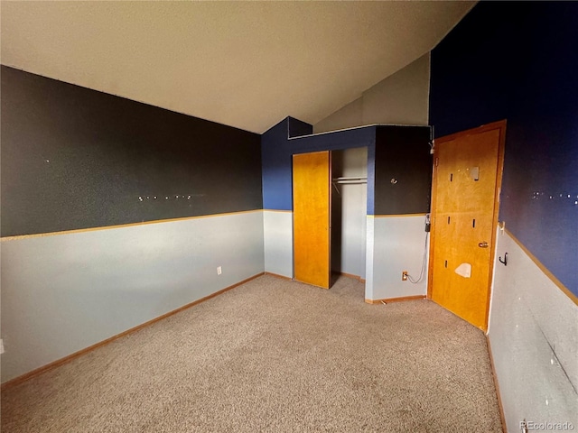 10064 Westside Cir, Littleton, CO 80125 - unfurnished bedroom with carpet, vaulted ceiling, and a closet