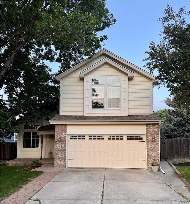 10064 Westside Cir, Littleton, CO 80125 - traditional-style house with brick siding, an attached garage, a shingled roof, and concrete driveway