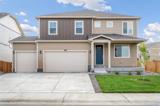 view of front of property with a garage and a front lawn