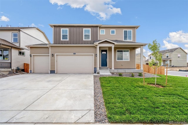 view of front of home with a garage, a front yard, and covered porch