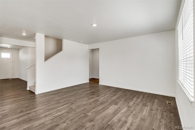 unfurnished living room with dark hardwood / wood-style flooring