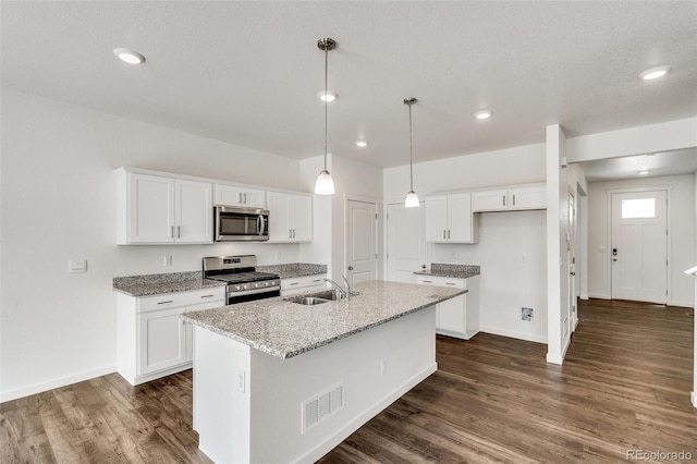 kitchen featuring light stone countertops, white cabinetry, appliances with stainless steel finishes, and sink