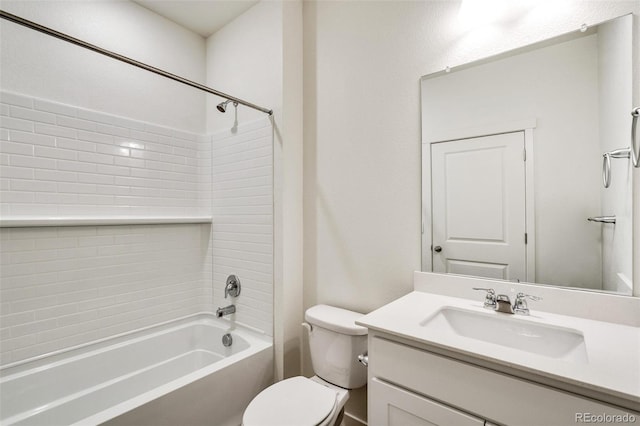 full bathroom with tiled shower / bath, vanity, and toilet