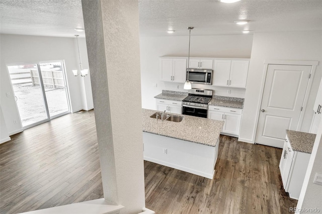 kitchen with sink, a textured ceiling, white cabinets, and appliances with stainless steel finishes