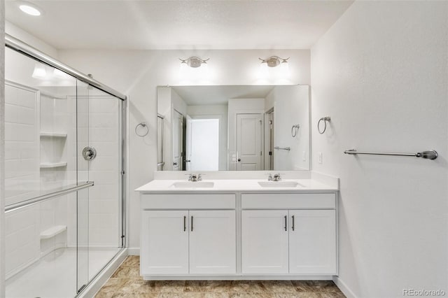 bathroom featuring walk in shower and vanity