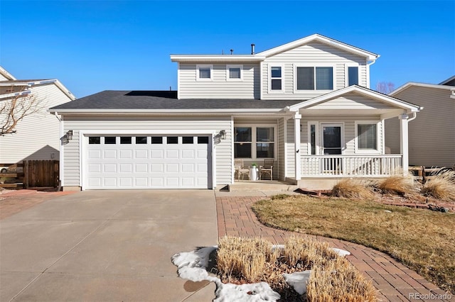 view of front of property featuring a front lawn, covered porch, and a garage