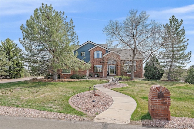 traditional home with a front lawn and brick siding