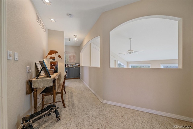 corridor featuring recessed lighting, visible vents, arched walkways, carpet floors, and baseboards