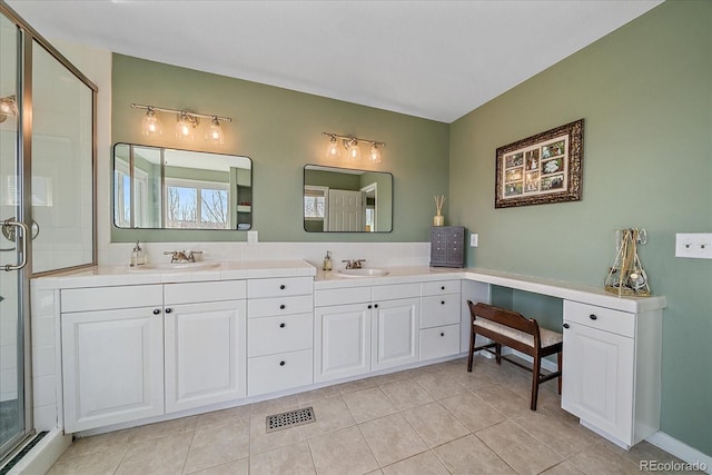 full bathroom featuring a shower stall, tile patterned floors, a sink, and visible vents