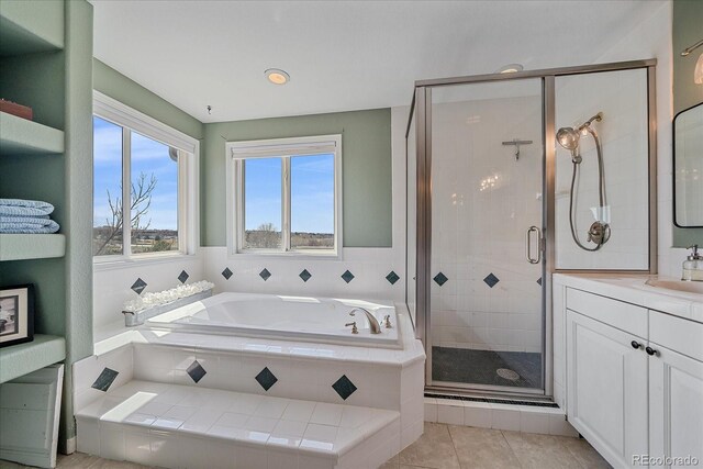 full bathroom featuring a bath, vanity, tile patterned floors, and a stall shower