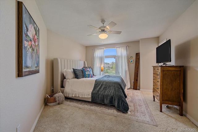 bedroom featuring ceiling fan, baseboards, and light colored carpet