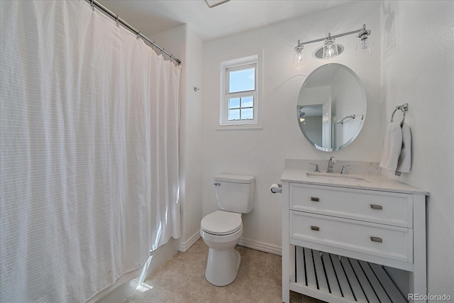 full bath with baseboards, vanity, tile patterned flooring, and toilet