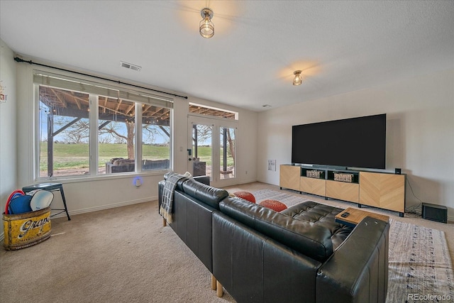 living room with visible vents, baseboards, and carpet
