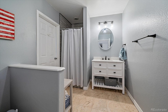 full bathroom with baseboards, vanity, and a shower with curtain