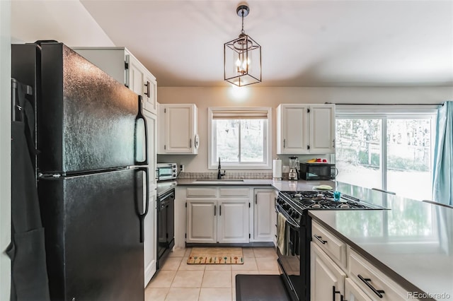 7256 Aspen Meadow Dr, Evergreen, CO 80439 - kitchen with black appliances, light tile patterned floors, white cabinets, decorative light fixtures, and a chandelier