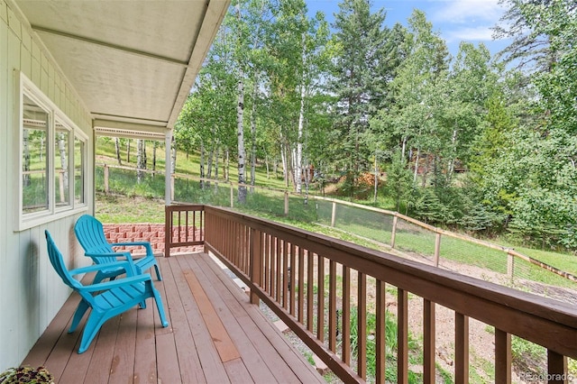 7256 Aspen Meadow Dr, Evergreen, CO 80439 - wooden deck featuring view of wooded area