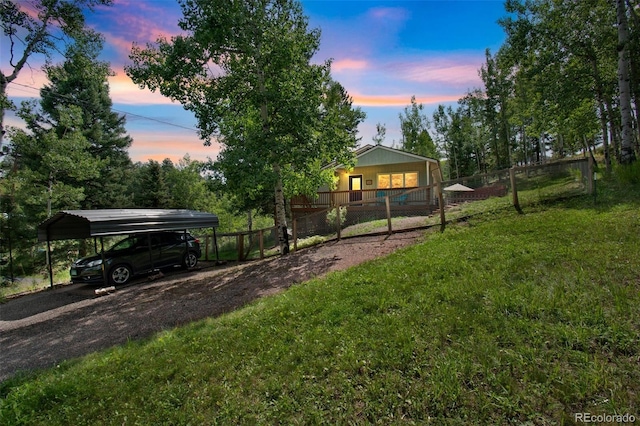 7256 Aspen Meadow Dr, Evergreen, CO 80439 - yard at dusk featuring a carport, driveway, and covered porch