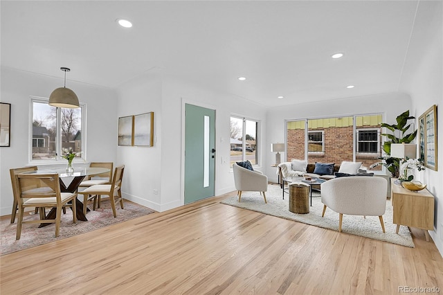 living room with recessed lighting, baseboards, and light wood-style flooring