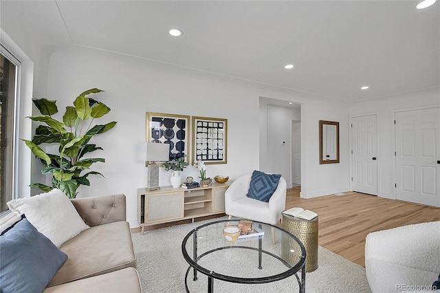 living room featuring recessed lighting, baseboards, and wood finished floors