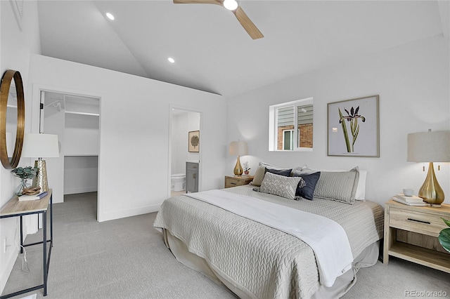 carpeted bedroom featuring a walk in closet, vaulted ceiling, recessed lighting, a closet, and ensuite bath