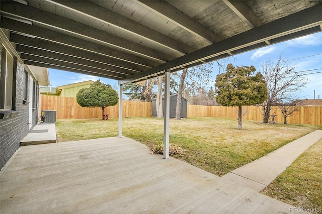 exterior space with a shed, central AC unit, a lawn, a fenced backyard, and an outdoor structure