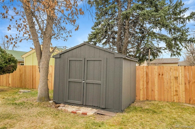 view of shed featuring fence