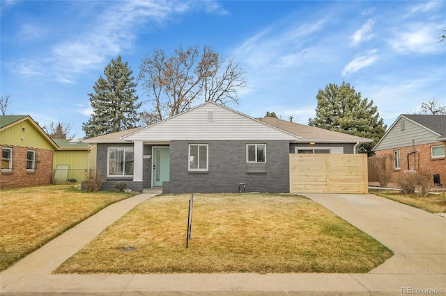 ranch-style home with a front yard, a gate, fence, and driveway