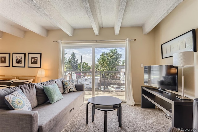 living room with carpet, a textured ceiling, and beamed ceiling