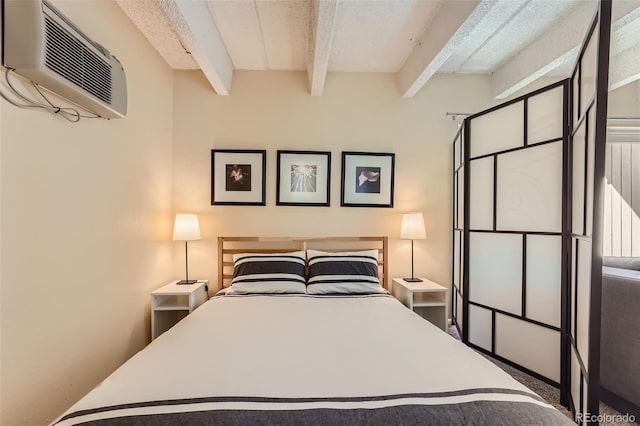 bedroom with beamed ceiling and an AC wall unit