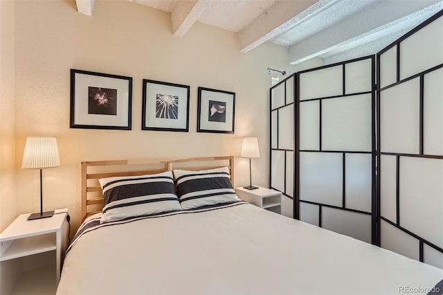 bedroom with beam ceiling