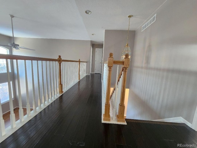 corridor featuring dark hardwood / wood-style floors and a textured ceiling