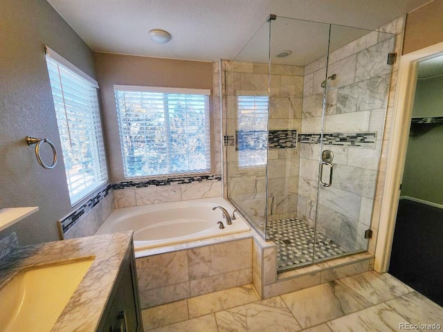 bathroom featuring vanity and independent shower and bath