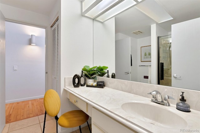 6681 S Abilene Way, Centennial, CO 80111 - bathroom featuring a stall shower, baseboards, visible vents, tile patterned flooring, and vanity