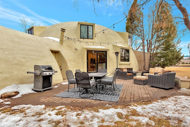 6681 S Abilene Way, Centennial, CO 80111 - snow covered house with a patio, stucco siding, and an outdoor living space