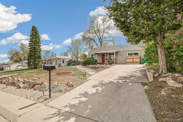 single story home with an attached garage, covered porch, and driveway
